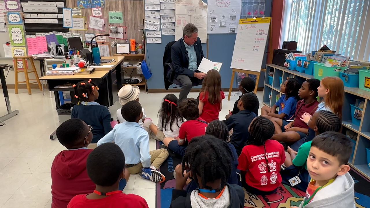  Superintendent Burke reads to a classroom of children at Crosspointe Elementary.